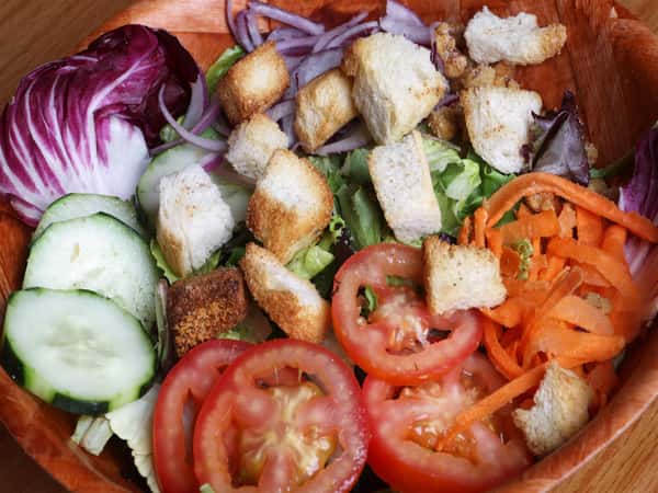 salad with lettuce, tomato, carrots, cucumber and croutons