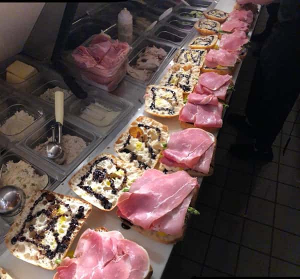 Ham sandwiches lined up and being prepared