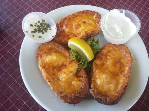 Baked potatoes served with dipping sauces