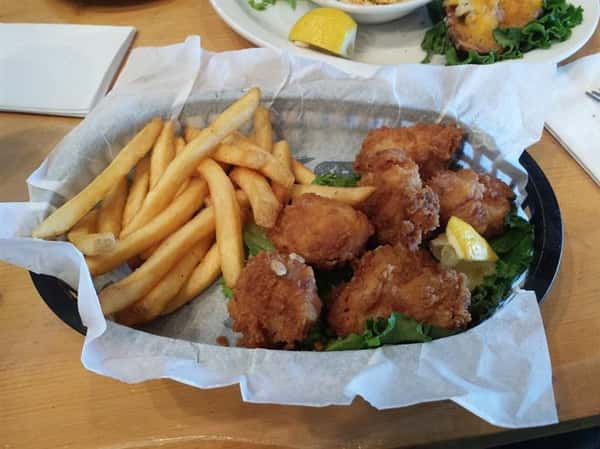 Fried fish served with side salad