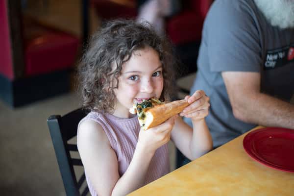 kid eating pizza