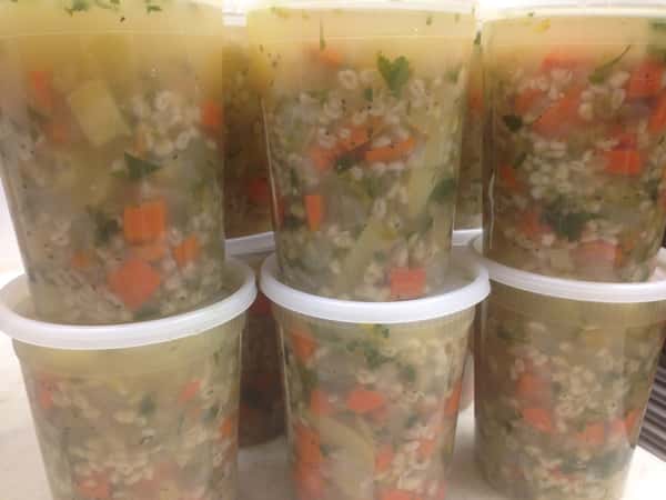 Stacked containers of vegetable soup