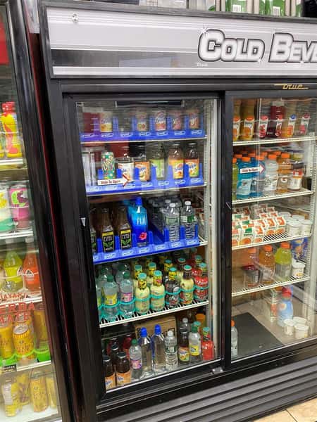 refrigerator full of various bottled beverages