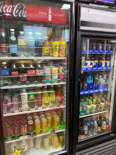 two refrigerators full of various bottled beverages