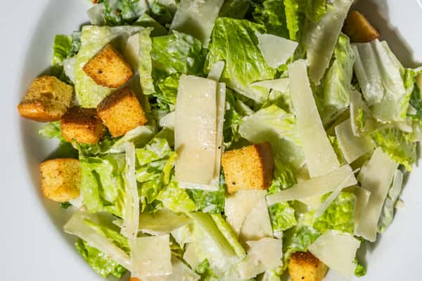 Crisp Caesar salad with romaine lettuce, shaved parmesan, and crunchy croutons tossed in creamy dressing. A fresh, vibrant starter ideal for pairing with wood-fired pizzas or grilled entrees.