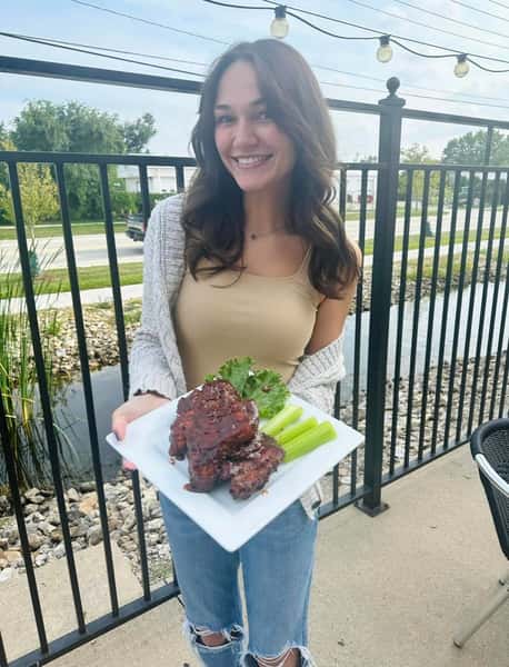 a woman holding a plate of food