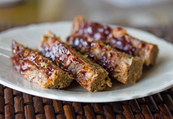 Dessert bars glazed with a shiny topping on a white plate
