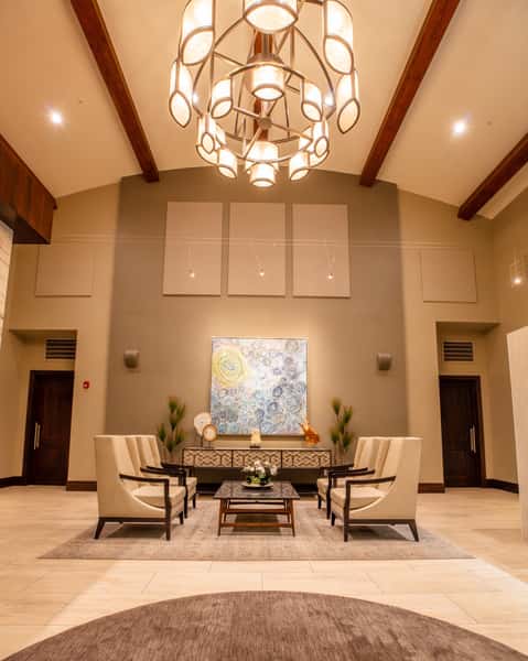 Grand dining room at Dulivia Ristorante Italiano in Springdale, Utah, with soaring ceilings, elegant chandeliers, contemporary artwork, and a romantic upscale atmosphere.