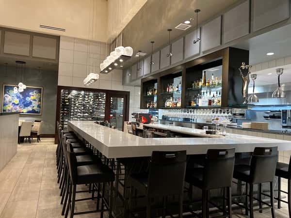 Modern bar at Dulivia Ristorante Italiano in Springdale, Utah, featuring premium wines, handcrafted cocktails, and stylish seating in an upscale Italian restaurant.
