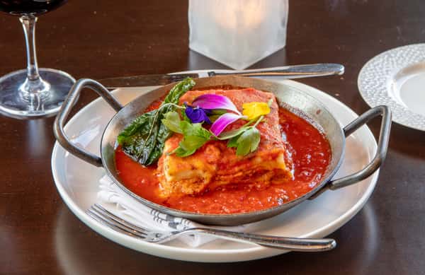 Chicken Parmesan with house-made marinara, melted mozzarella, and fresh basil at Dulivia Ristorante Italiano in Springdale, Utah.