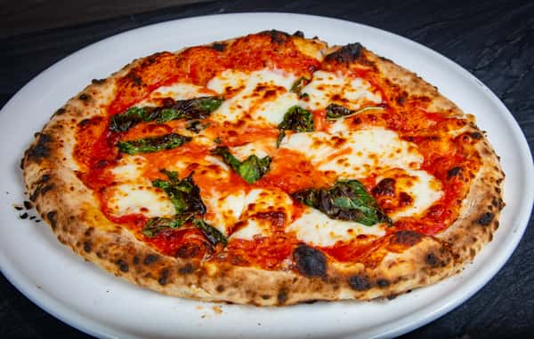 Stone-hearth Margherita pizza with fresh mozzarella, basil, and house-made tomato sauce at Dulivia Ristorante Italiano in Springdale, Utah.
