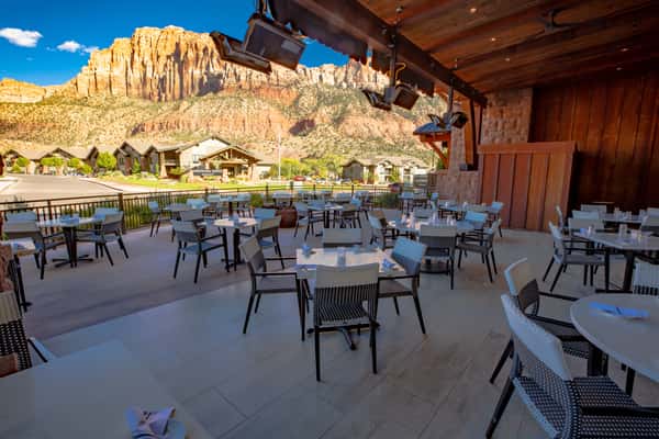 Covered patio dining at Dulivia Ristorante Italiano in Springdale, Utah, featuring outdoor seating with stunning views near Zion National Park.