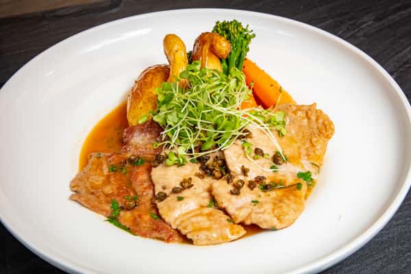 Grilled chicken with roasted vegetables in a savory Italian cream sauce at Dulivia Ristorante Italiano in Springdale, Utah.