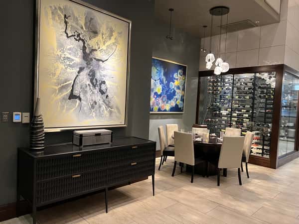 Elegant dining area at Dulivia Ristorante Italiano in Springdale, Utah, featuring contemporary artwork, warm lighting, and an upscale atmosphere for romantic dinners and special occasions.