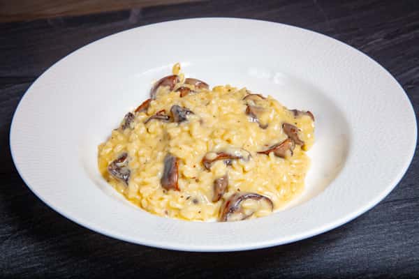 Creamy mushroom risotto with Parmesan and sautéed mushrooms at Dulivia Ristorante Italiano in Springdale, Utah.