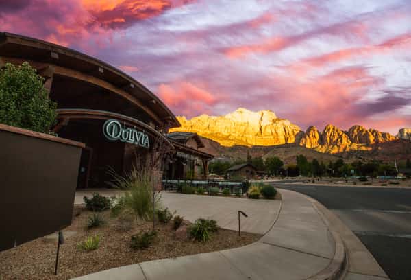 Dulivia Ristorante Italiano at sunset in Springdale, Utah, with glowing red rock mountain views and an elegant exterior near Zion National Park.