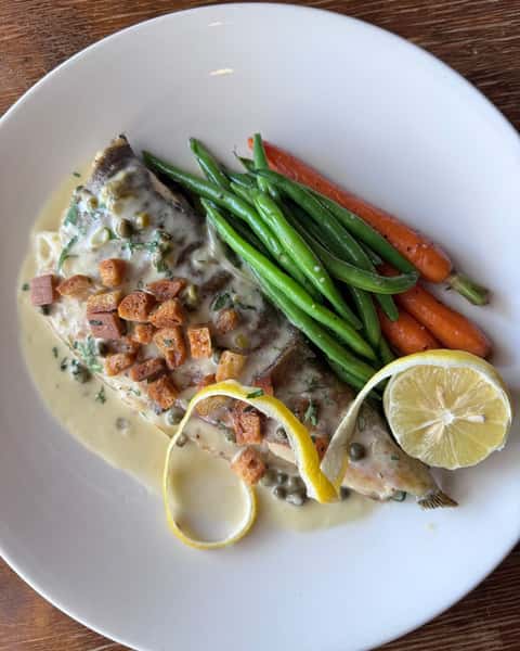 Truite Grenobloise- Trout with caper butter sauce, croutons, and root vegetables. Bright, buttery, and beautifully balanced. A classic French preparation that lets the fish shine.

#frenchrestaurant  #houstontexas #ricevillage  #riceuniversity #winebar
