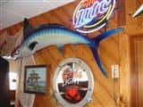 mounted fish and beer signs on wall