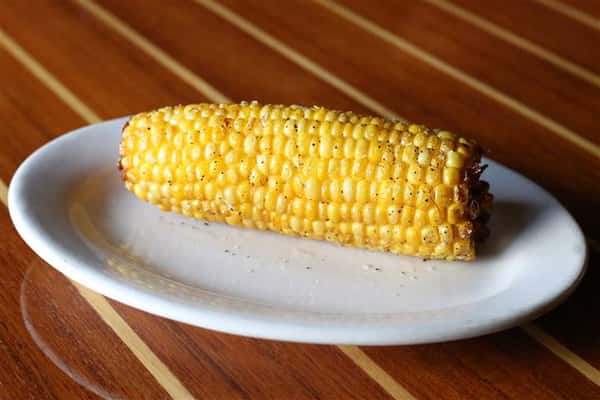 Ear of corn on the cob on a plate.