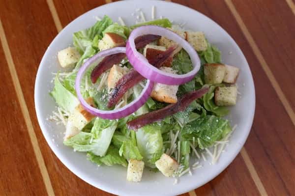 Caesar - Romaine hearts with shredded parmesan, red onion, fresh croutons & anchovies