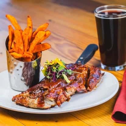 Sweet potato fries served with a dark beer