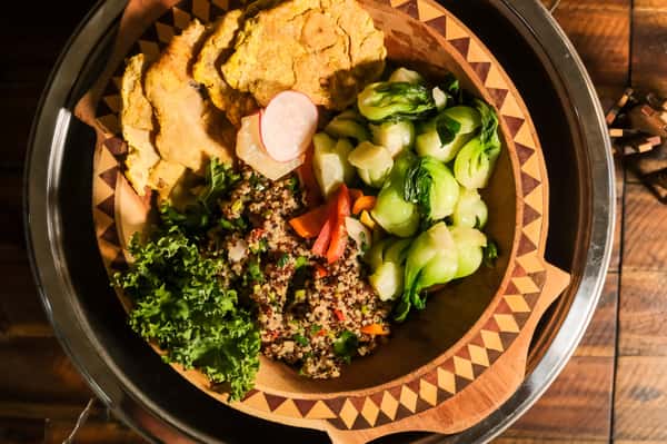 bowl with empanadas, veggies, and quinoa