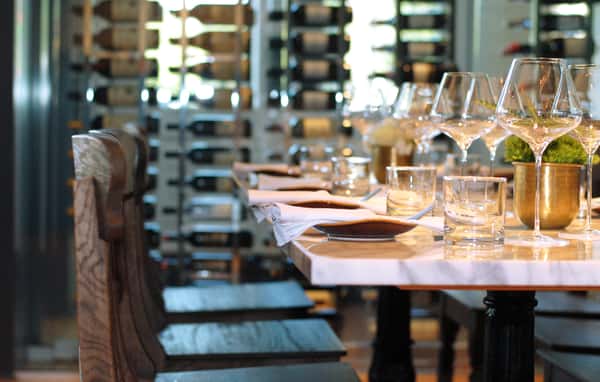 marble table top set with place settings and wine glasses