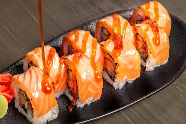 adding sauce to sushi