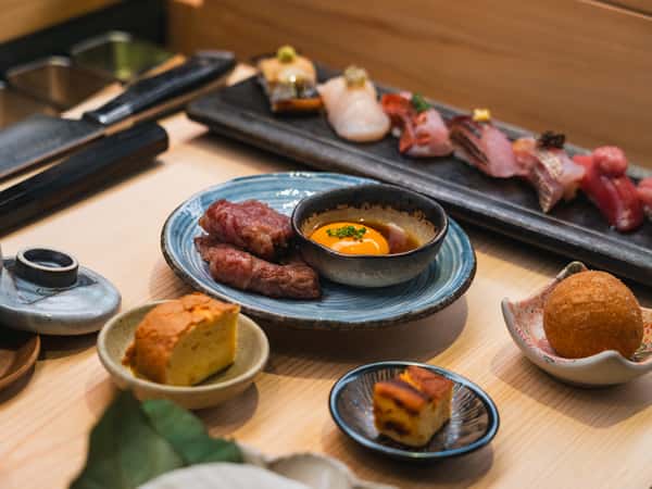 Blue Ribbon Sushi omakase spread featuring premium nigiri, seared Wagyu with egg yolk and Japanese small plates in Pacific Palisades