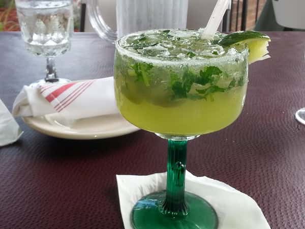 Lime margarita with lime wedge