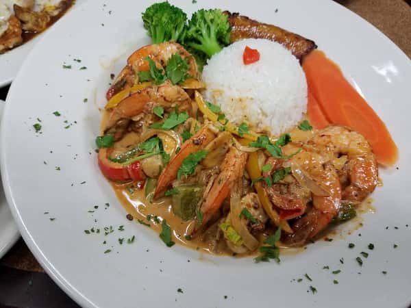 Shrimp in a sauce with a scoop of rice
