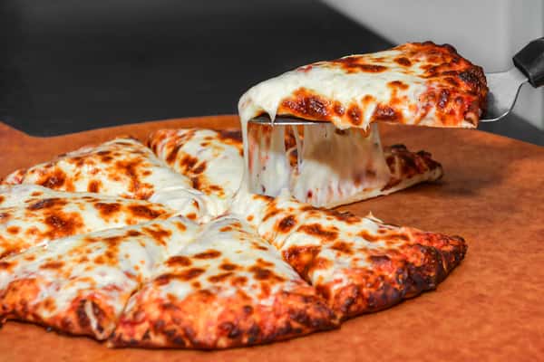 A slice of cheesy pizza being pulled up
