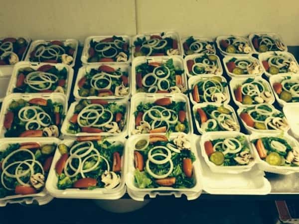 catering display of salads in takeout trays