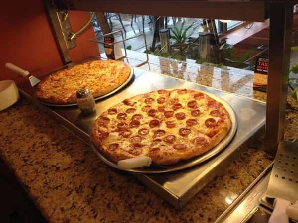 pizza pies displayed on pans