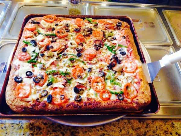SICILIAN STYLE PIZZA with black olives and tomatoes