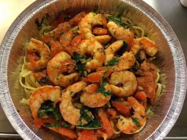 shrimp and pasta in a takeout tray