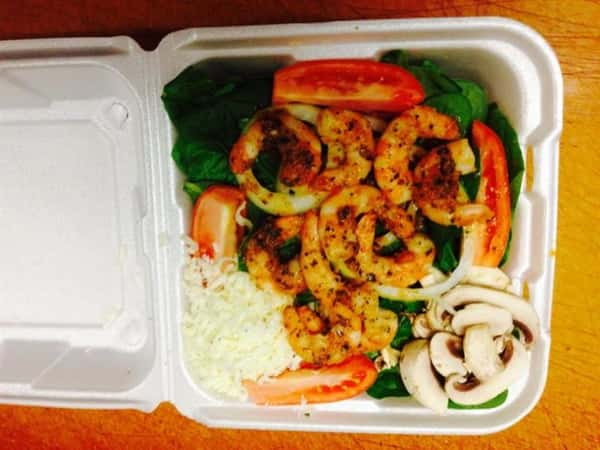 shrimp salad and rice in a takeout tray
