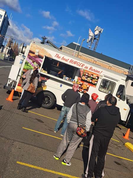 Tilted shot of food truck with a line of people waiting to order