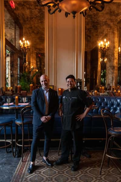 Two smiling staff members
