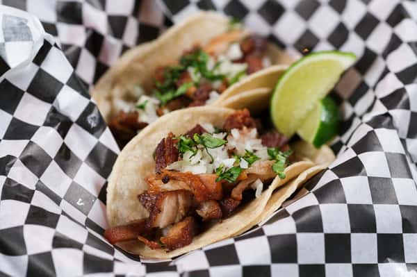 Enjoy our street-style tacos— Choice of juicy chicken or tender marinated steak, both served in warm corn tortillas. Topped with fresh cilantro, diced onions, and a squeeze of lime. Served with a side of zesty salsa.