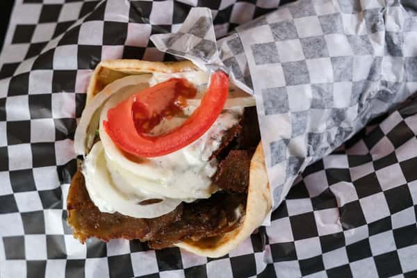 A classic Greek favorite with a Chicago twist! Savory, seasoned gyro meat—thinly sliced and seared to perfection—wrapped in a warm, fluffy pita. Topped with crisp lettuce, ripe tomatoes, sliced onions, and creamy homemade tzatziki sauce.