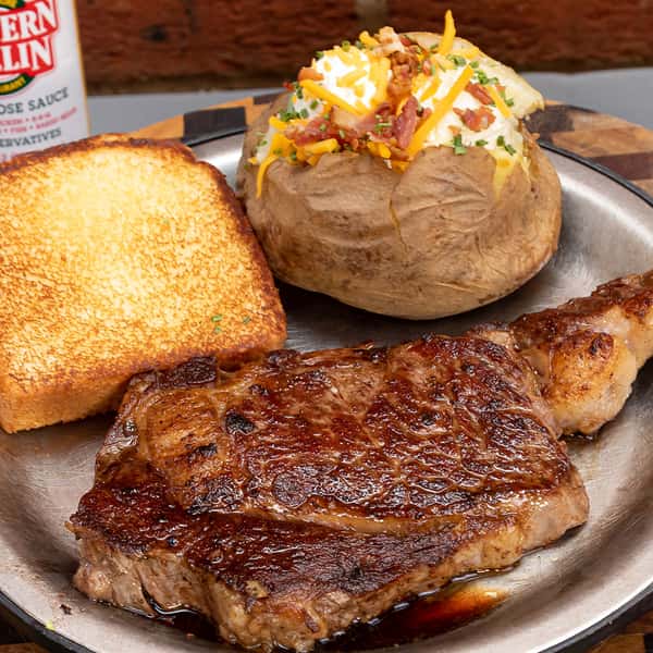 pork chop and bread with baked potato