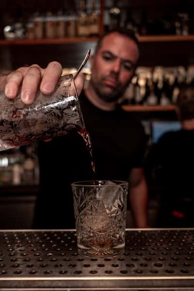 man pouring cocktail
