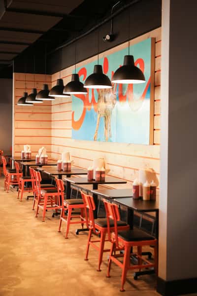 indoor seating area with large pig painting
