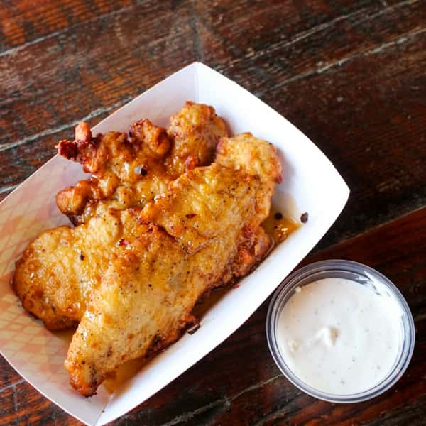 Crispy Social Burger chicken tenders served with creamy ranch dipping sauce, perfect as a flavorful appetizer or snack.