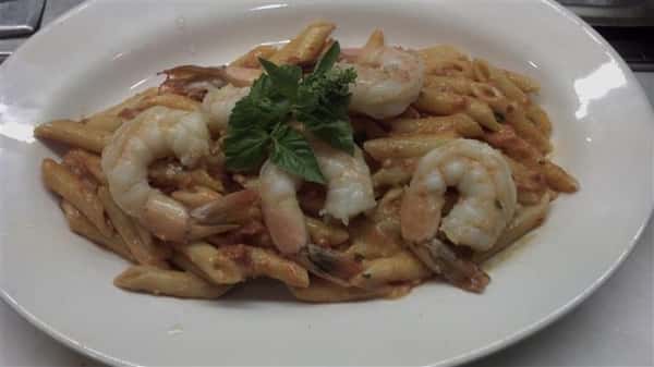 Penne pasta in a light cream sauce with shrimp.