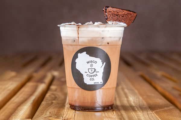 Iced brownie latte topped with whipped cream and a chocolate brownie at Wisco Coffee Company