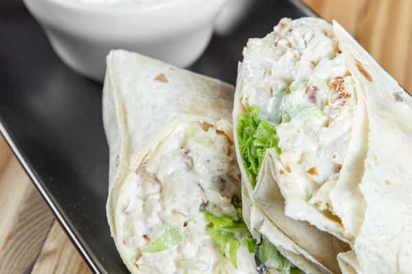 Chicken salad wrap with lettuce in a soft tortilla at Wisco Coffee Company