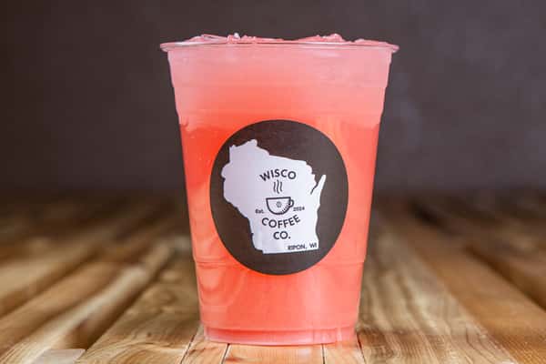 Refreshing strawberry lemonade with a soft pink hue and ice cubes, captured from above on a wooden table, showcasing a bright and fruity summer café beverage.