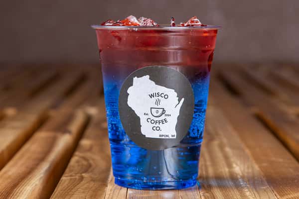 Top view of vibrant red iced drink with ice cubes at Wisco Coffee Company